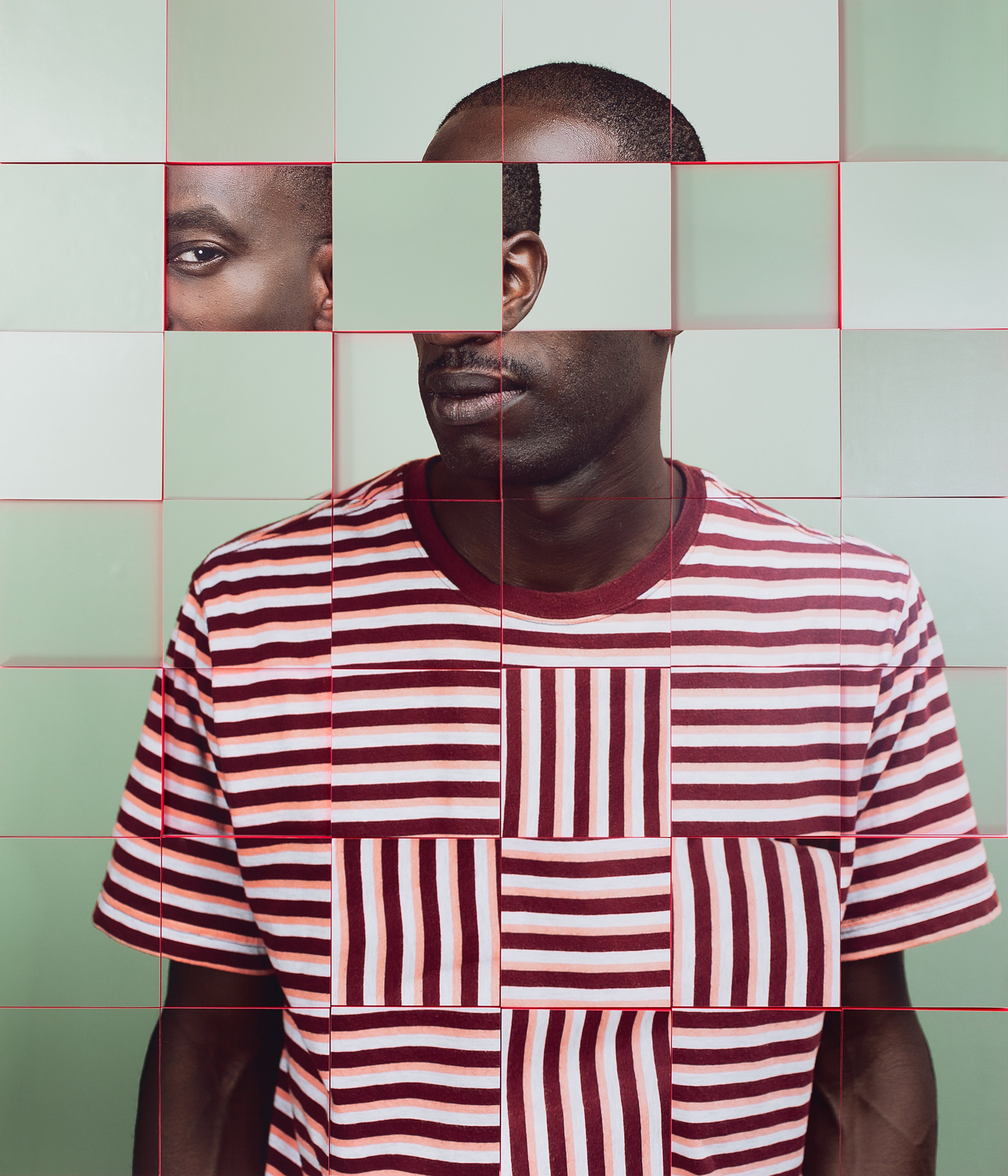 Portrait of a black man in bright striped shirt broken up alike to a square jigsaw, looking at the camera.